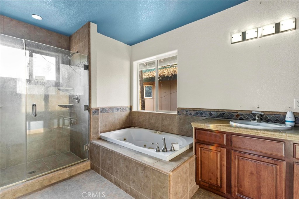 10761 Texas Hill Road Dobbins, CA 95935 - Photo 22 of 58 a bathroom with a granite countertop sink a bathtub and shower