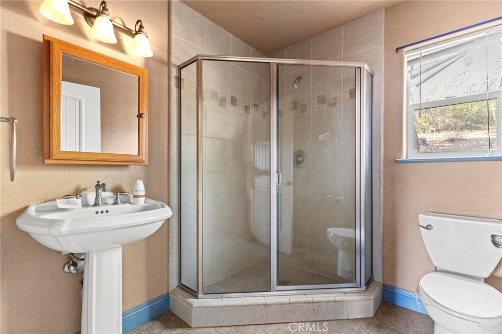 10761 Texas Hill Road Dobbins, CA 95935 - Photo 24 of 58 a bathroom with a sink toilet and shower