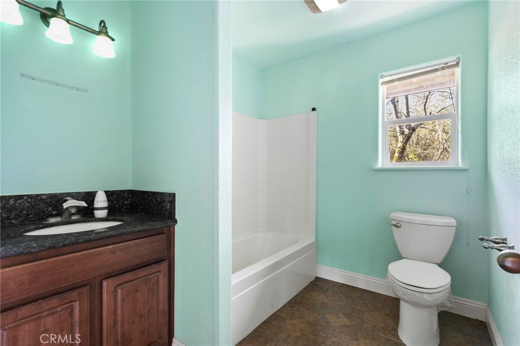 10761 Texas Hill Road Dobbins, CA 95935 - Photo 25 of 58 a bathroom with a granite countertop toilet and sink
