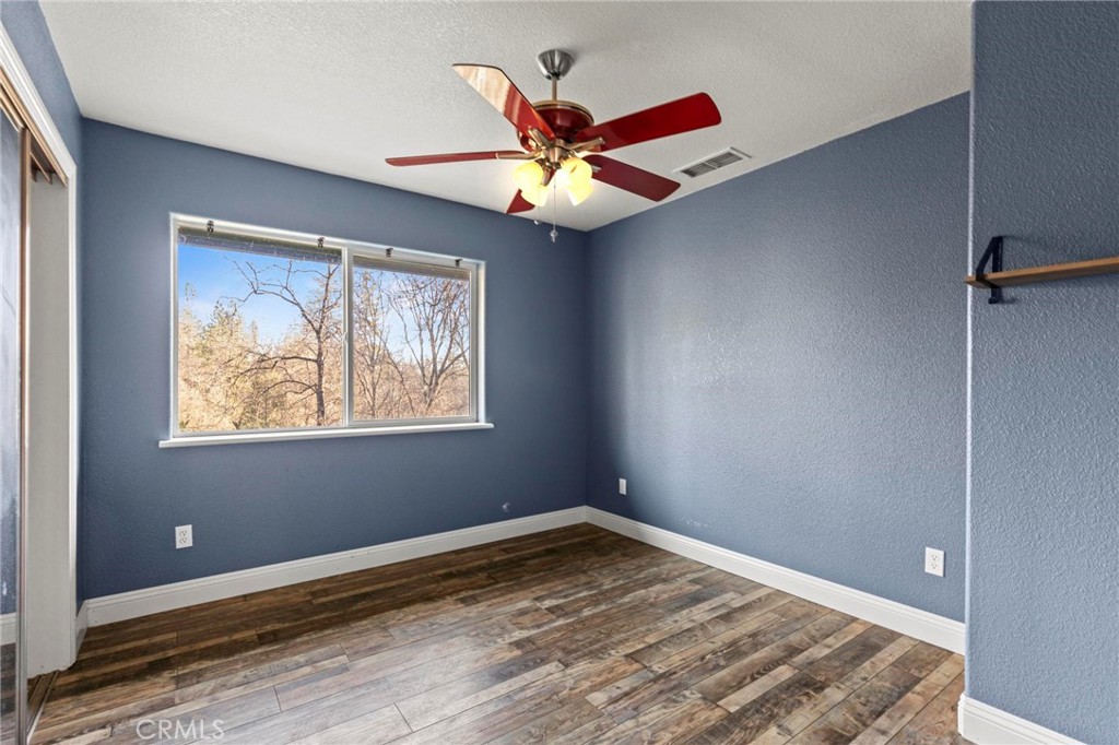 10761 Texas Hill Road Dobbins, CA 95935 - Photo 27 of 58 an empty room with windows and fan