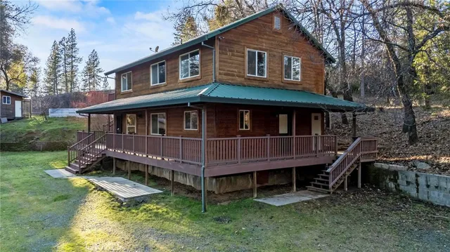a view of a house with a yard and sitting area