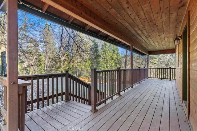 a view of an empty room with kitchen and a window