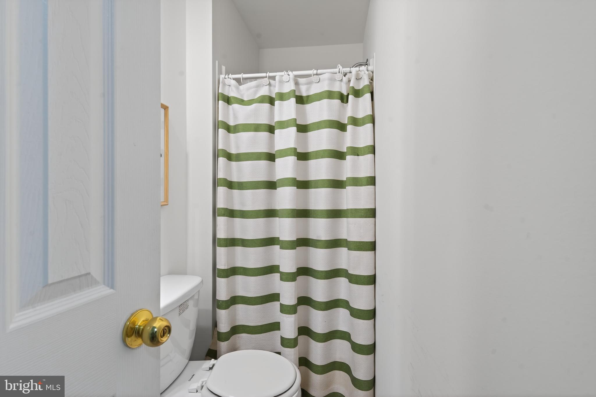 23616 Public House Road Clarksburg, MD 20871 - Photo 23 of 35 a bathroom with a toilet and a shower curtain