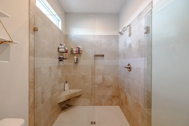 a bathroom with a shower and toilet