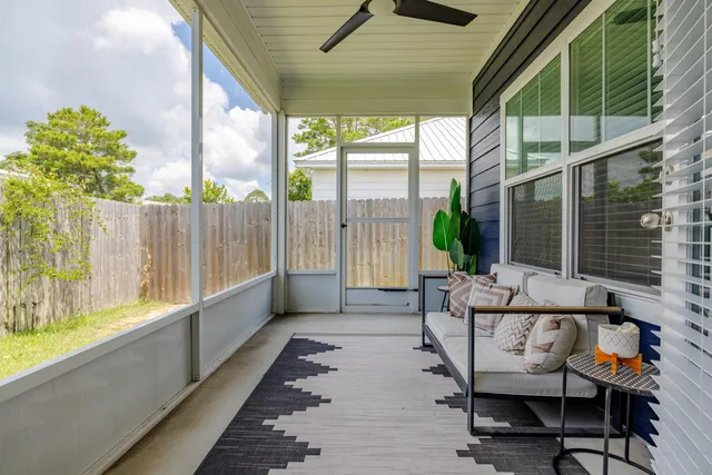 a balcony with furniture and a potted plant