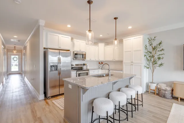 a large kitchen with a table and chairs