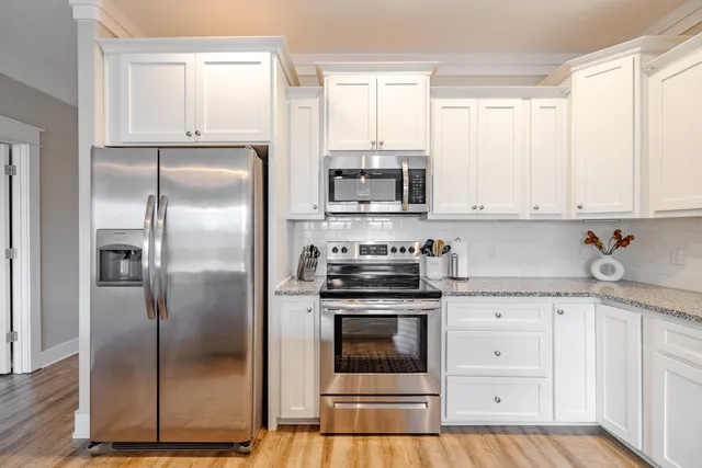 a kitchen with stainless steel appliances granite countertop a refrigerator sink and cabinets