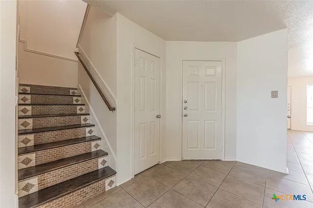 a kitchen with stainless steel appliances granite countertop a refrigerator and a stove