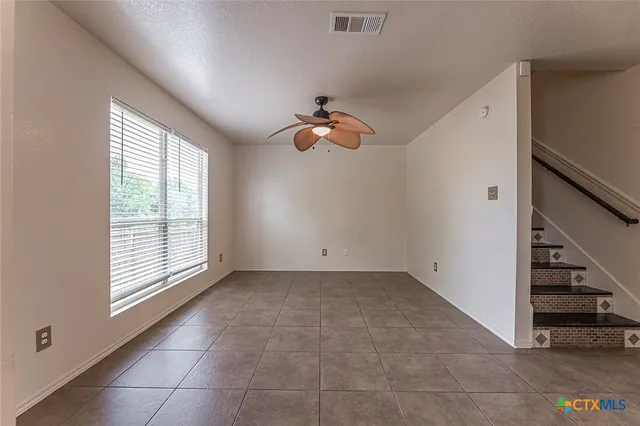 an empty room with a window and flowerpot
