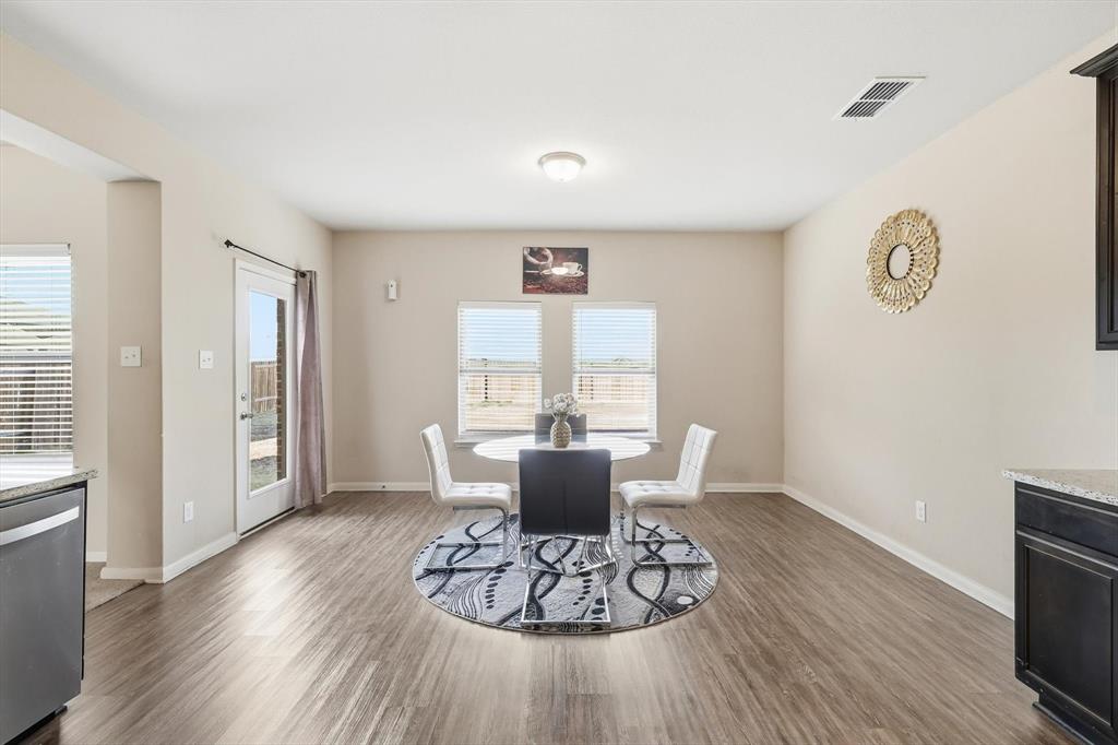 227 Curt Street Anna, TX 75409 - Photo 12 of 40 a dining room with wooden floor and a chandelier