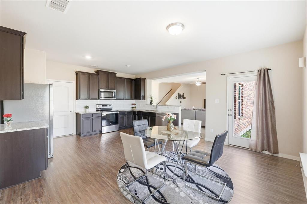 227 Curt Street Anna, TX 75409 - Photo 14 of 40 a dining room with furniture and wooden floor