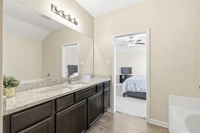 a bathroom with a tub and shower