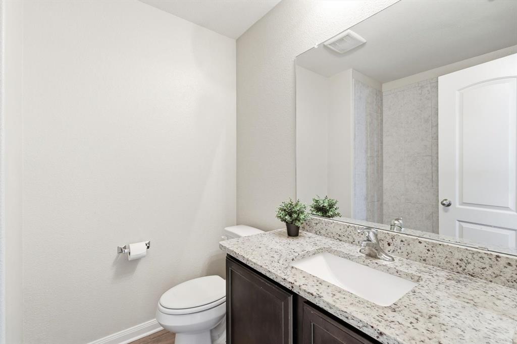 227 Curt Street Anna, TX 75409 - Photo 29 of 40 a bathroom with a granite countertop sink and a mirror