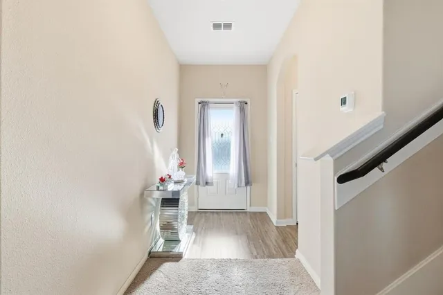 a view of a hallway with front door