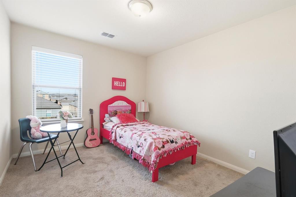 227 Curt Street Anna, TX 75409 - Photo 30 of 40 a bedroom with a bed and a dresser in it