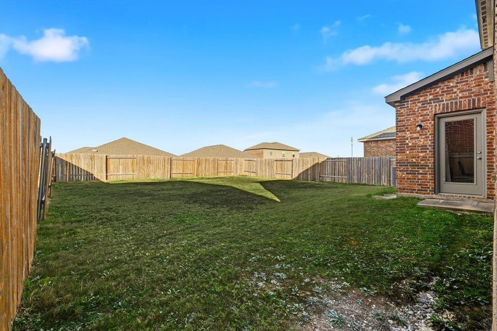 227 Curt Street Anna, TX 75409 - Photo 32 of 40 a view of an house with backyard space and garden