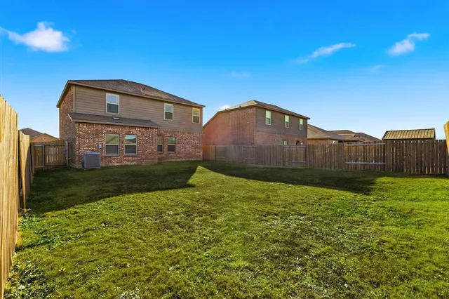a view of an house with backyard space and garden