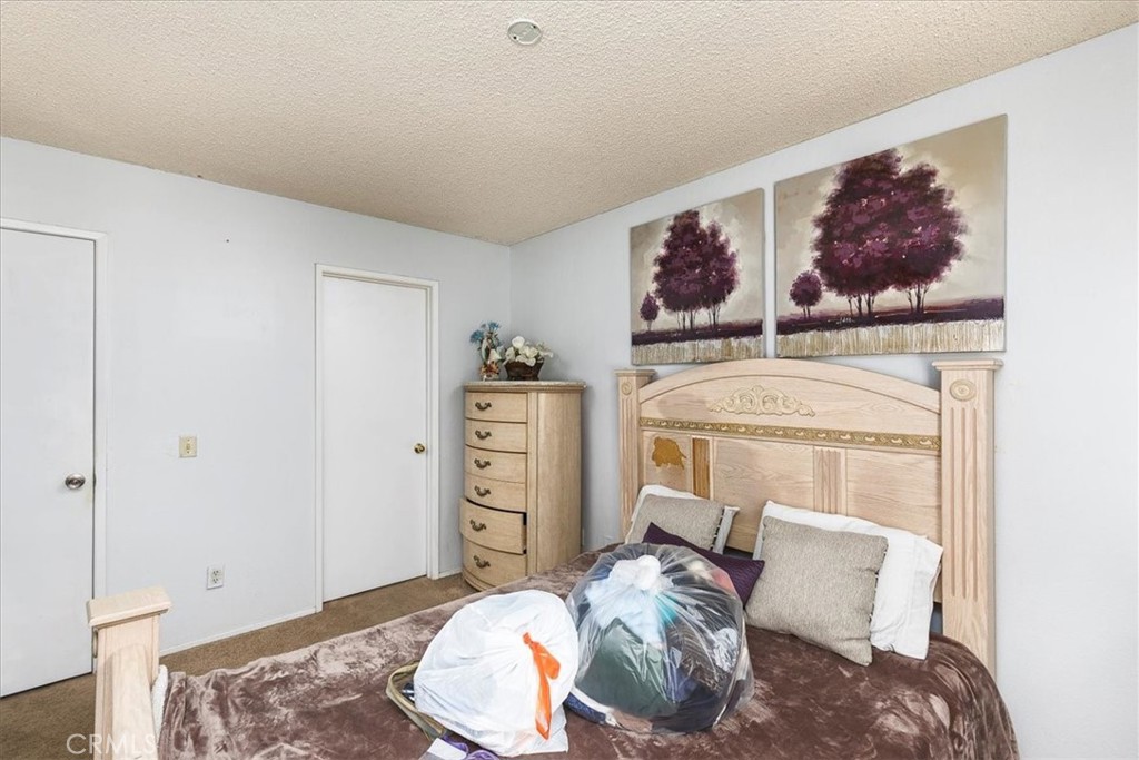 162 Peppertree Way San Jacinto, CA 92583 - Photo 14 of 23 a bedroom with a bed and a painting on the wall