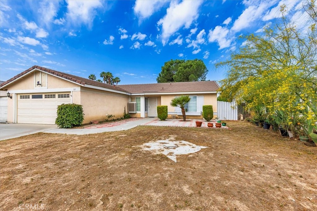 162 Peppertree Way San Jacinto, CA 92583 - Photo 3 of 23 a front view of a house with a yard and outdoor seating