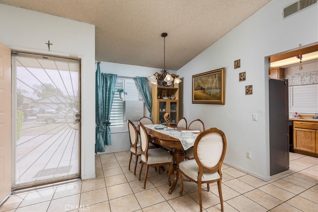 162 Peppertree Way San Jacinto, CA 92583 - Photo 5 of 23 a dining room with furniture a chandelier and window