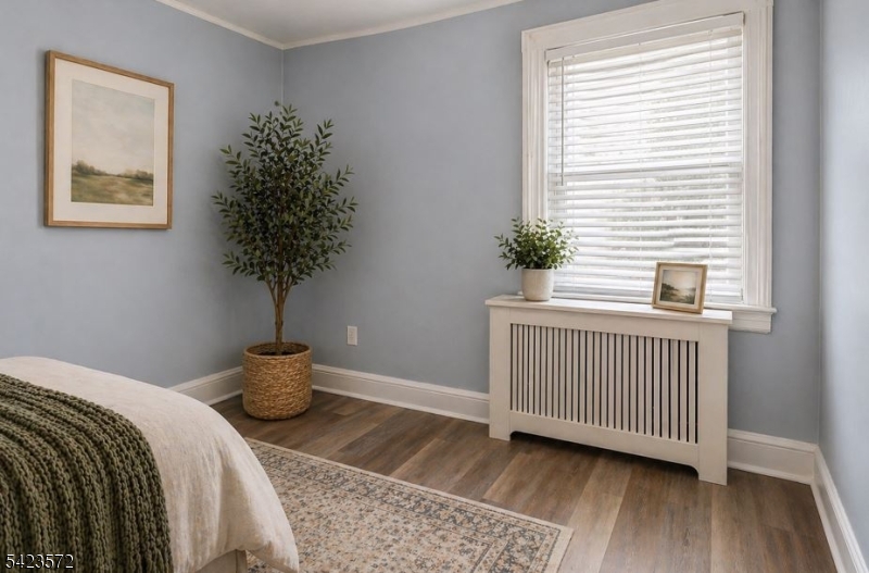 569 Chestnut Street Orange, NJ 07050 - Photo 5 of 9 a bedroom with a bed and a window