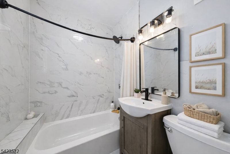 569 Chestnut Street Orange, NJ 07050 - Photo 6 of 9 a bathroom with a sink toilet and shower