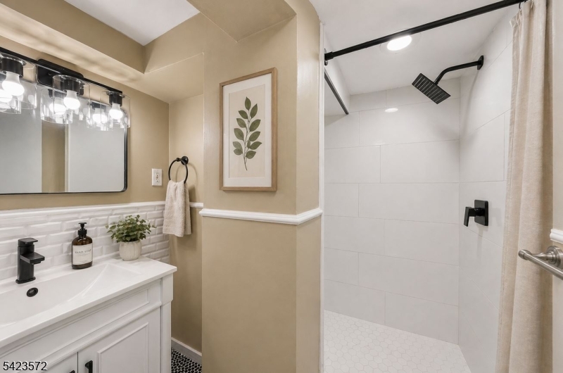 569 Chestnut Street Orange, NJ 07050 - Photo 7 of 9 a bathroom with a sink and a mirror