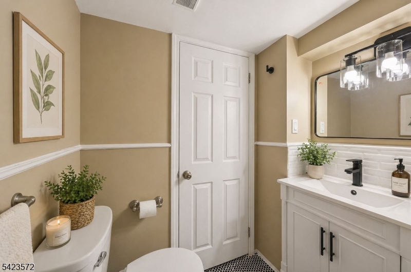 569 Chestnut Street Orange, NJ 07050 - Photo 8 of 9 a bathroom with a toilet a sink and a mirror