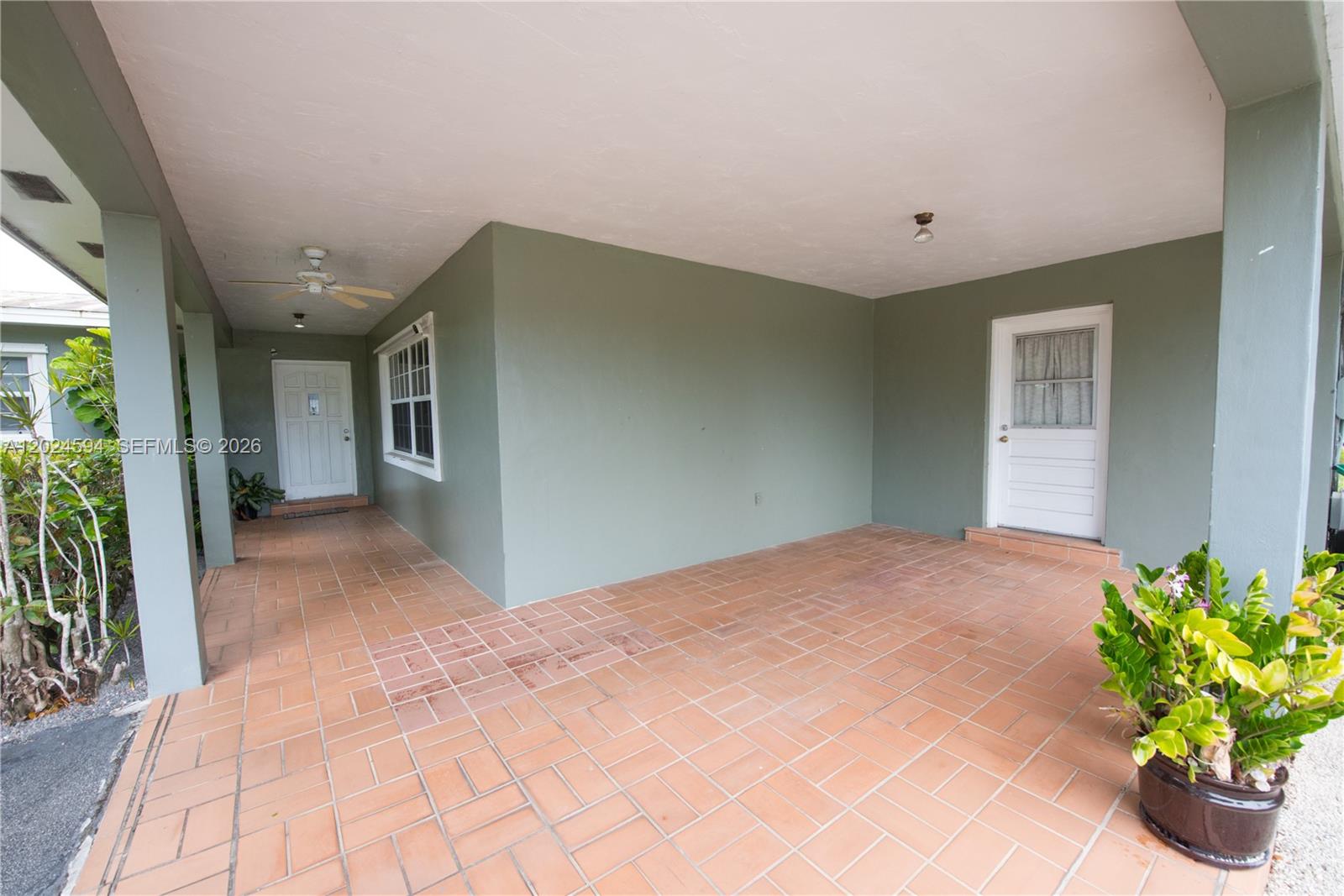 17355 Southwest 256th Street Homestead, FL 33031 - Photo 5 of 32 a view of a big room with windows and flower pot