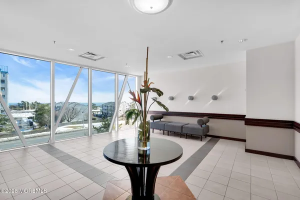 a living room with furniture large window and a flat screen tv