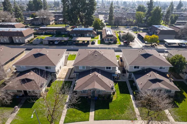 an aerial view of a house with a swimming pool and outdoor seating