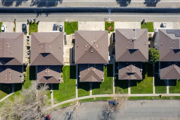 a aerial view of a house with a swimming pool and outdoor seating