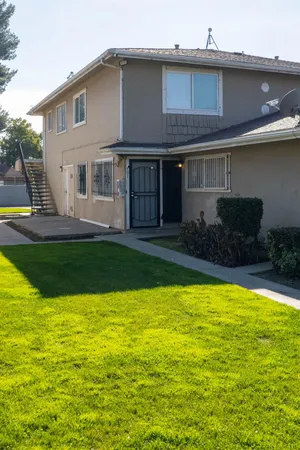 a view of a house with a yard patio and swimming pool