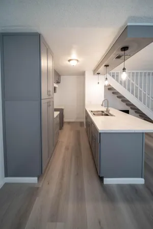 a kitchen with a sink and refrigerator