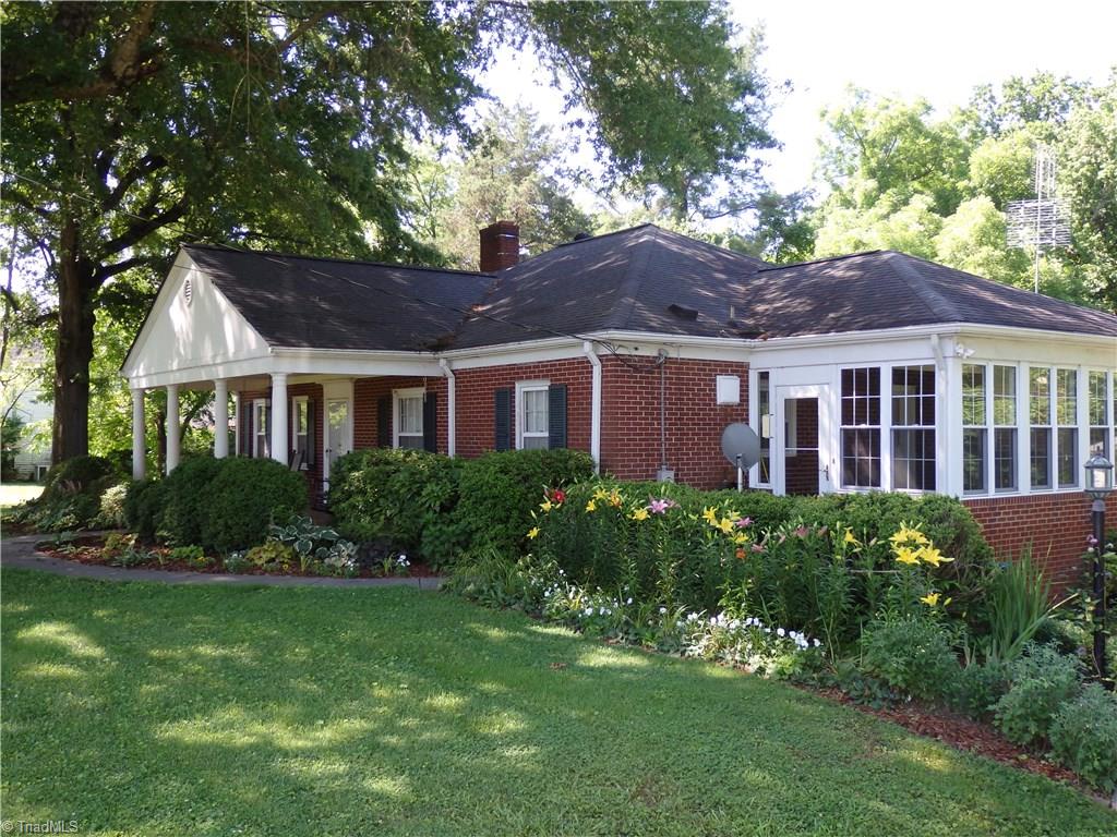 206 Coleridge Road Ramseur, NC 27316 - Photo 2 of 30 Front and side with lots on landscaping and flowers