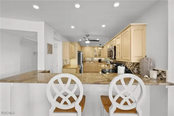 a view of a dining room with furniture large windows and wooden floor