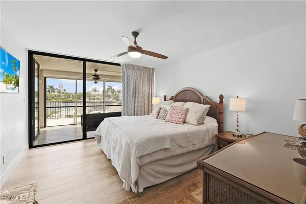 a bedroom with a bed couch and a large window