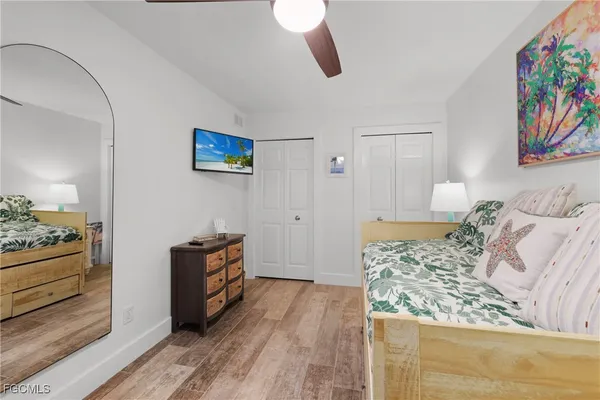 a bedroom with a bed and a painting on the wall