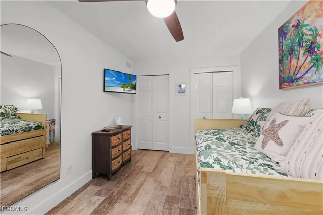 a bedroom with a bed and a painting on the wall