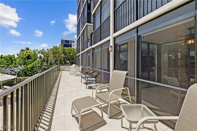 a view of a balcony with chair and iron fence