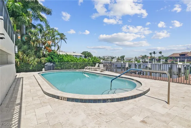 a view of a rooftop deck with dining table and chairs