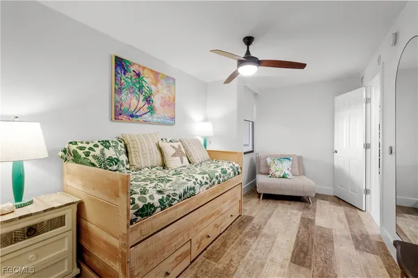 a bed room with a bed and a painting on the wall