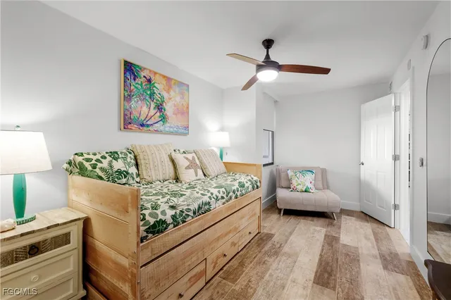 a bed room with a bed and a painting on the wall