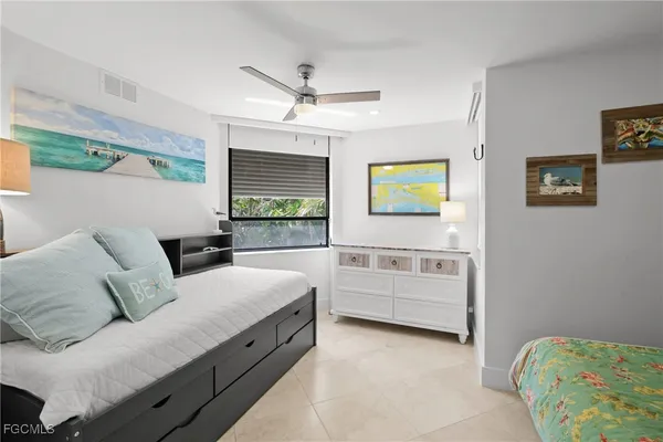 a living room with furniture and a baby crib