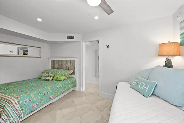 a bedroom with a bed and a couch