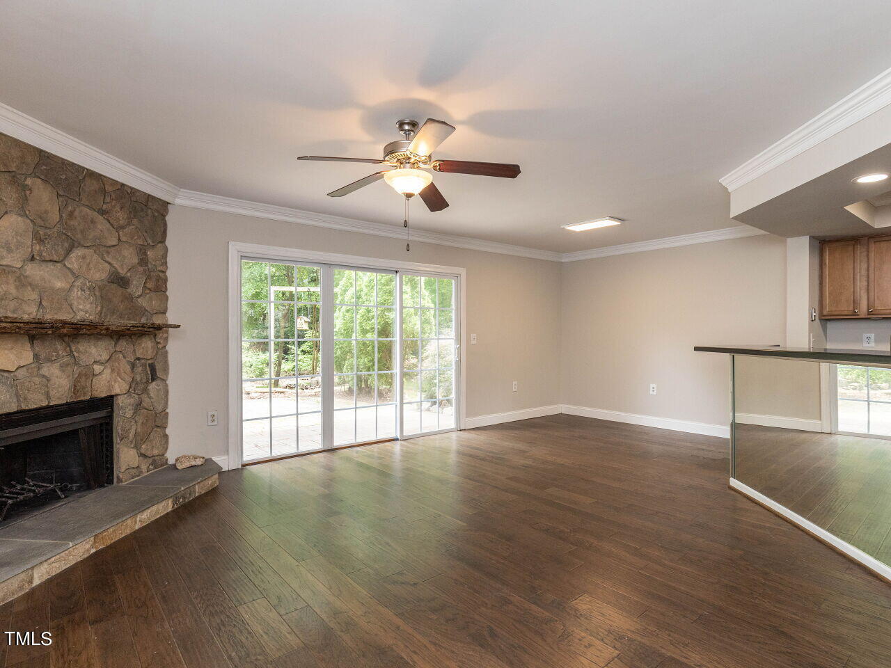 7833 Falcon Rest Circle Raleigh, NC 27615 - Photo 4 of 26 a view of an empty room with a window and wooden floor