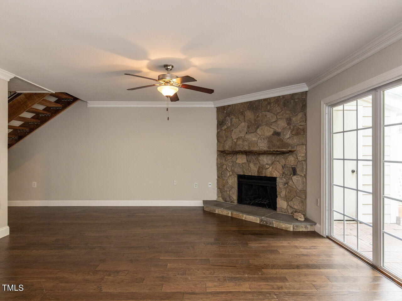 7833 Falcon Rest Circle Raleigh, NC 27615 - Photo 5 of 26 wooden floor fireplace and windows in an empty room