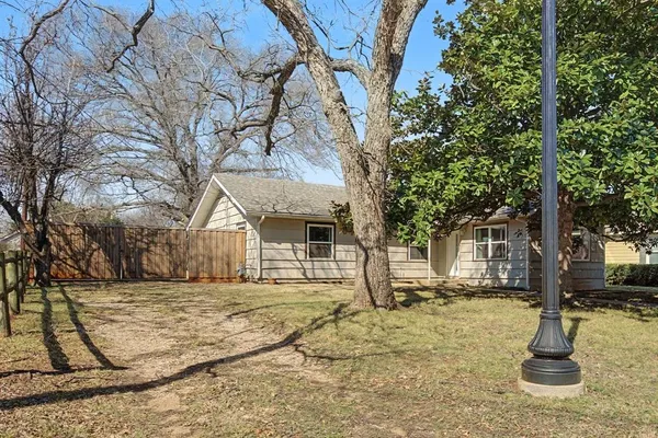 a house that has a tree in front of it