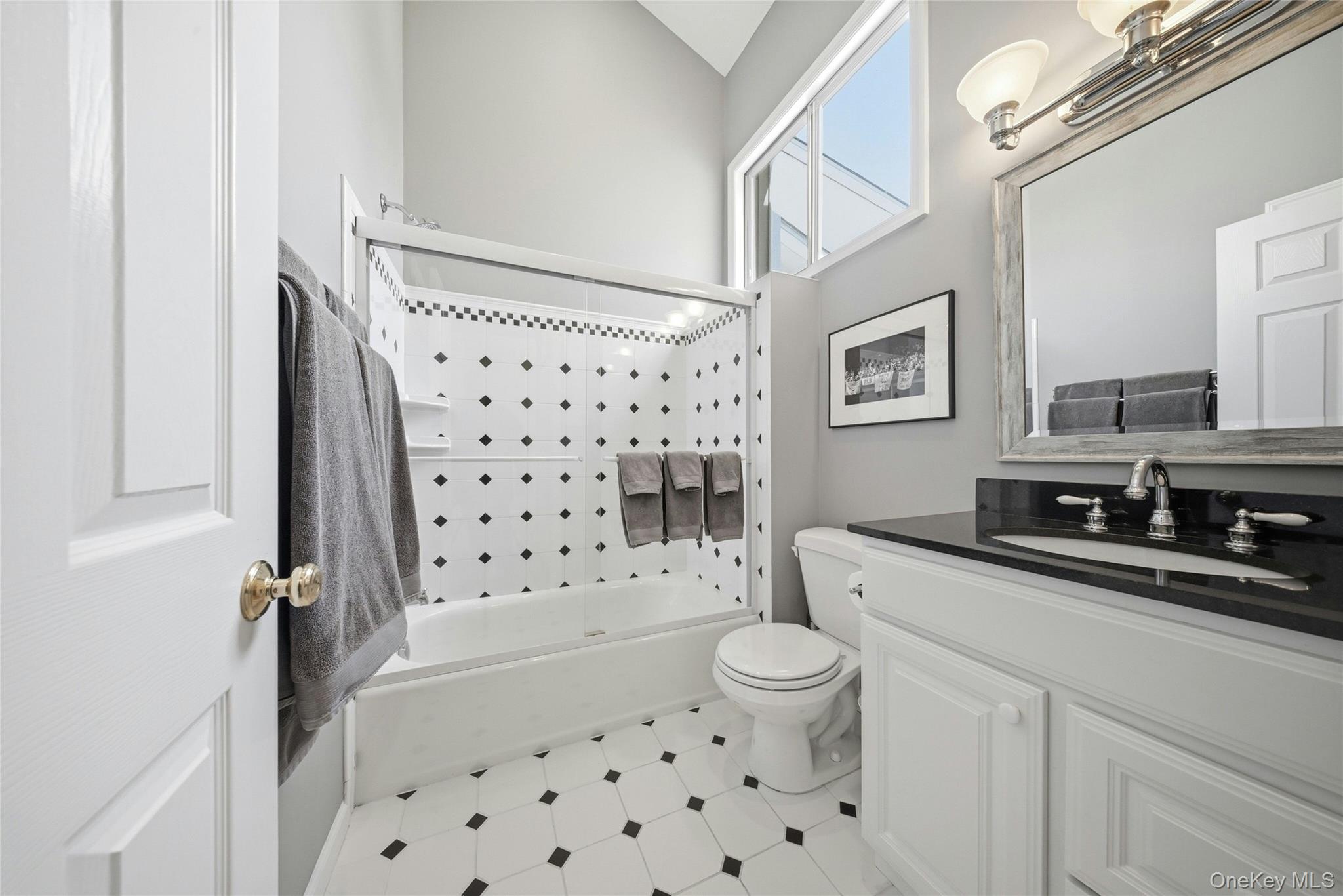 78 Hidden Ridge Drive Syosset, NY 11791 - Photo 16 of 21 a bathroom with a sink a toilet a mirror a vanity and shower