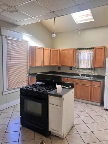 a kitchen with a stove a sink and a microwave